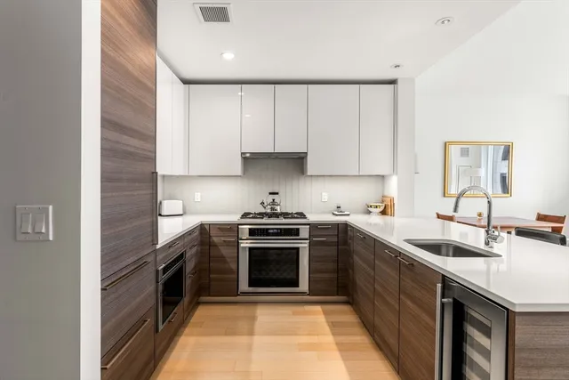 a kitchen with a sink stove and cabinets