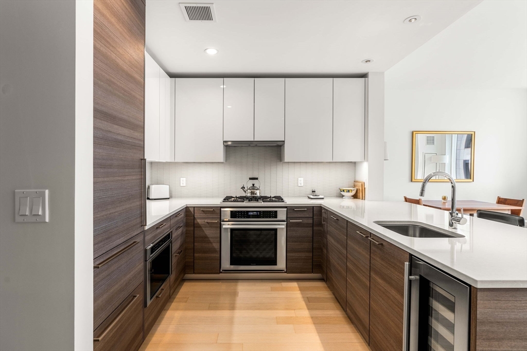 1 Franklin Street, Unit 2609 Boston, MA 02110 - Photo 8 of 24 a kitchen with a sink stove and cabinets