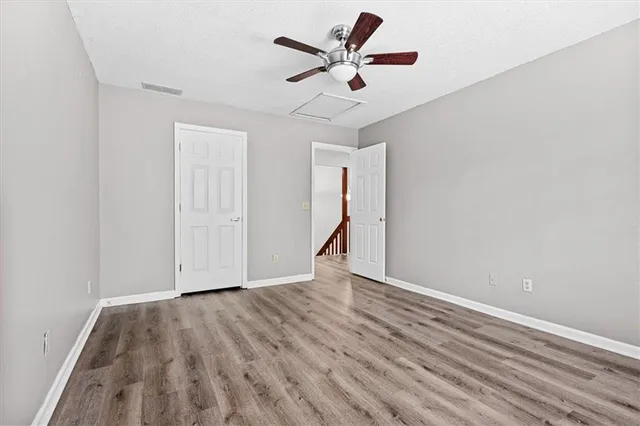 a view of an empty room with wooden floor
