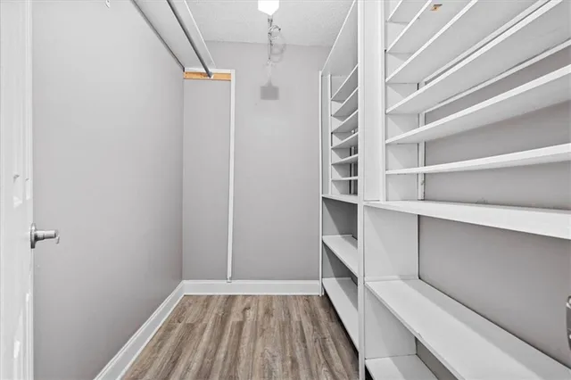 a view of walk in closet with empty racks