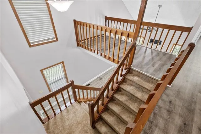 a view of staircase with black white walls and a window