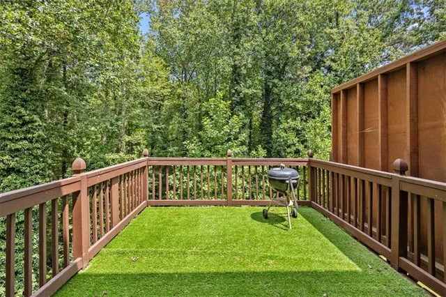 a view of balcony with wooden floor and fence