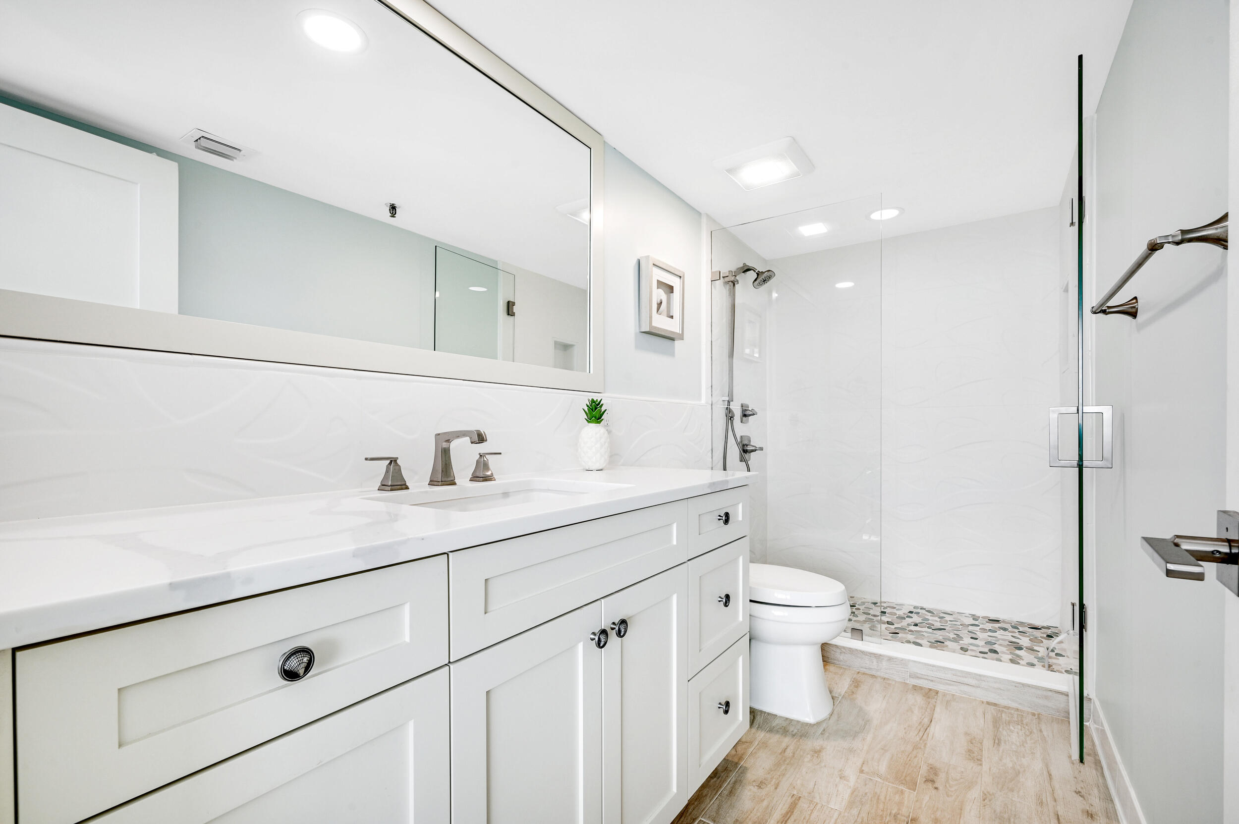 1300 Florida A1A, Unit 624 Jupiter, FL 33477 - Photo 15 of 35 a view of bathroom with a sink a toilet a large mirror and shower