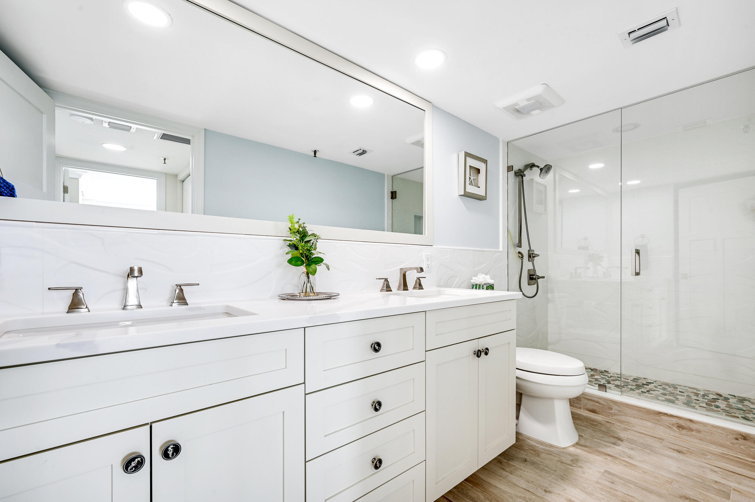 1300 Florida A1A, Unit 624 Jupiter, FL 33477 - Photo 19 of 35 a bathroom with a double vanity sink toilet mirror and shower