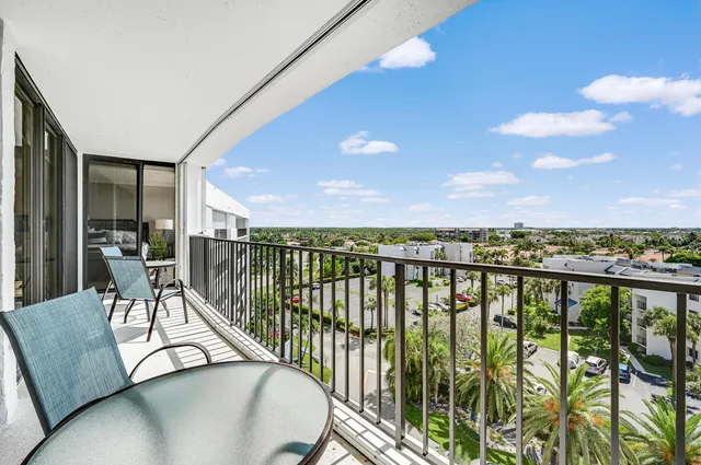 a view of a chairs and table in a balcony