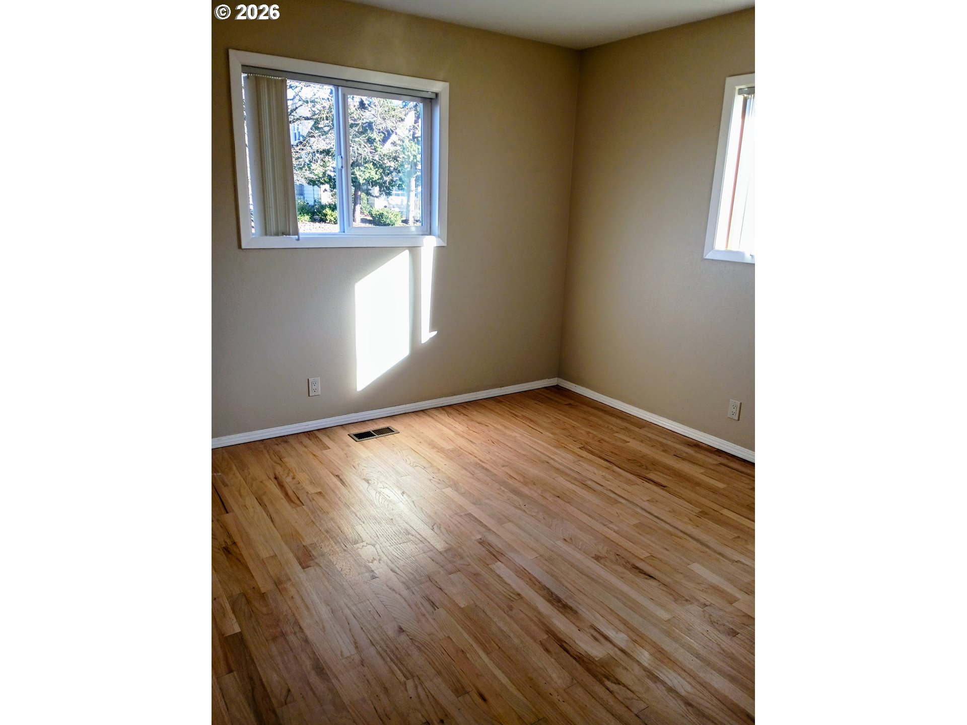 625 North Knights Bridge Road Canby, OR 97013 - Photo 9 of 18 a view of an empty room with wooden floor and a window