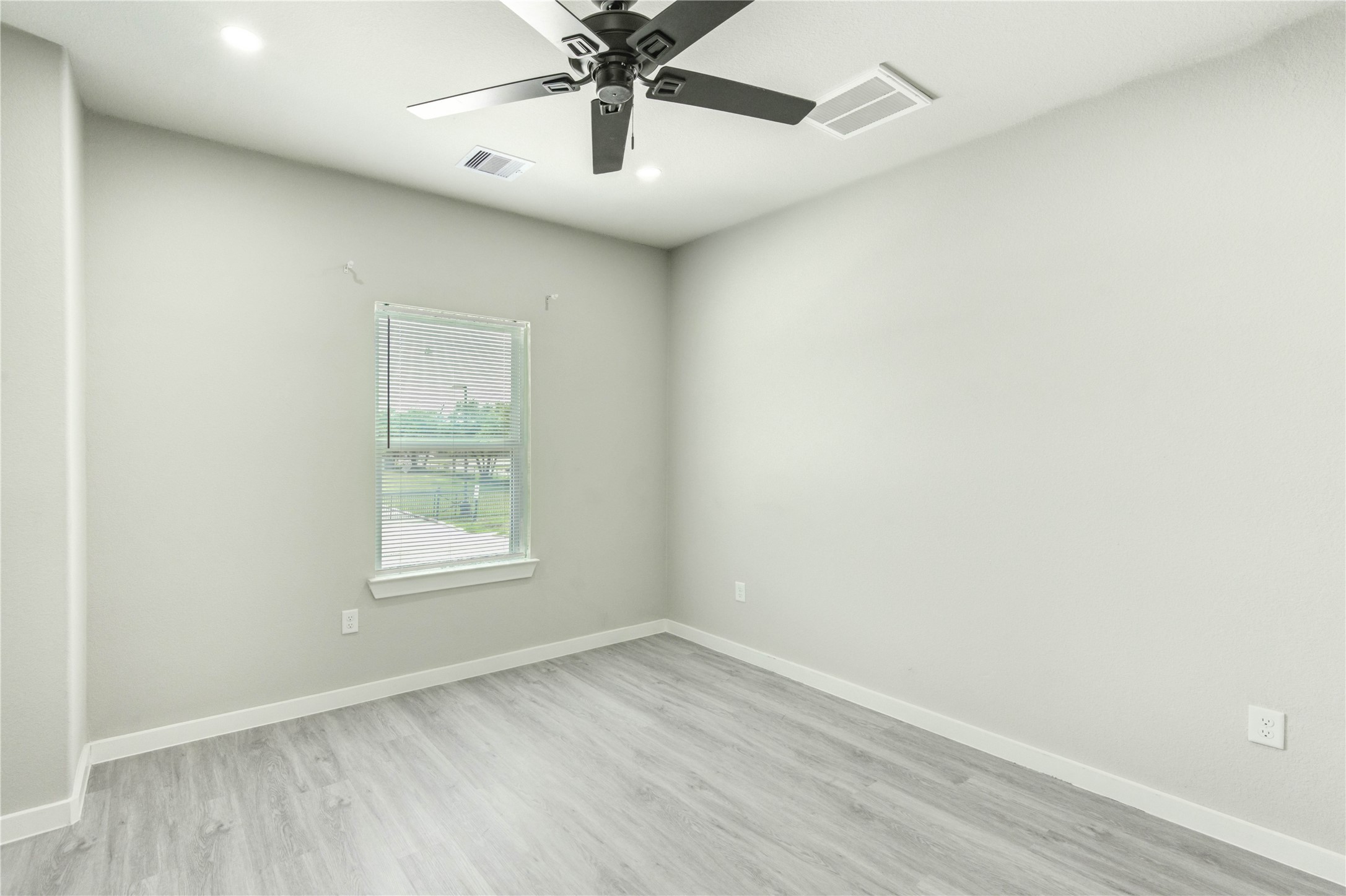 8157 Tate Street, Unit A Houston, TX 77028 - Photo 24 of 29 an empty room with a window and a fan