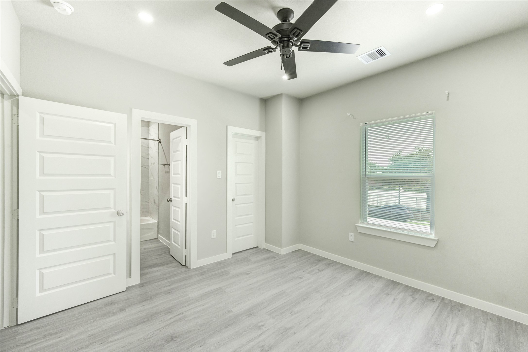 8157 Tate Street, Unit A Houston, TX 77028 - Photo 25 of 29 an empty room with wooden floor closet and windows