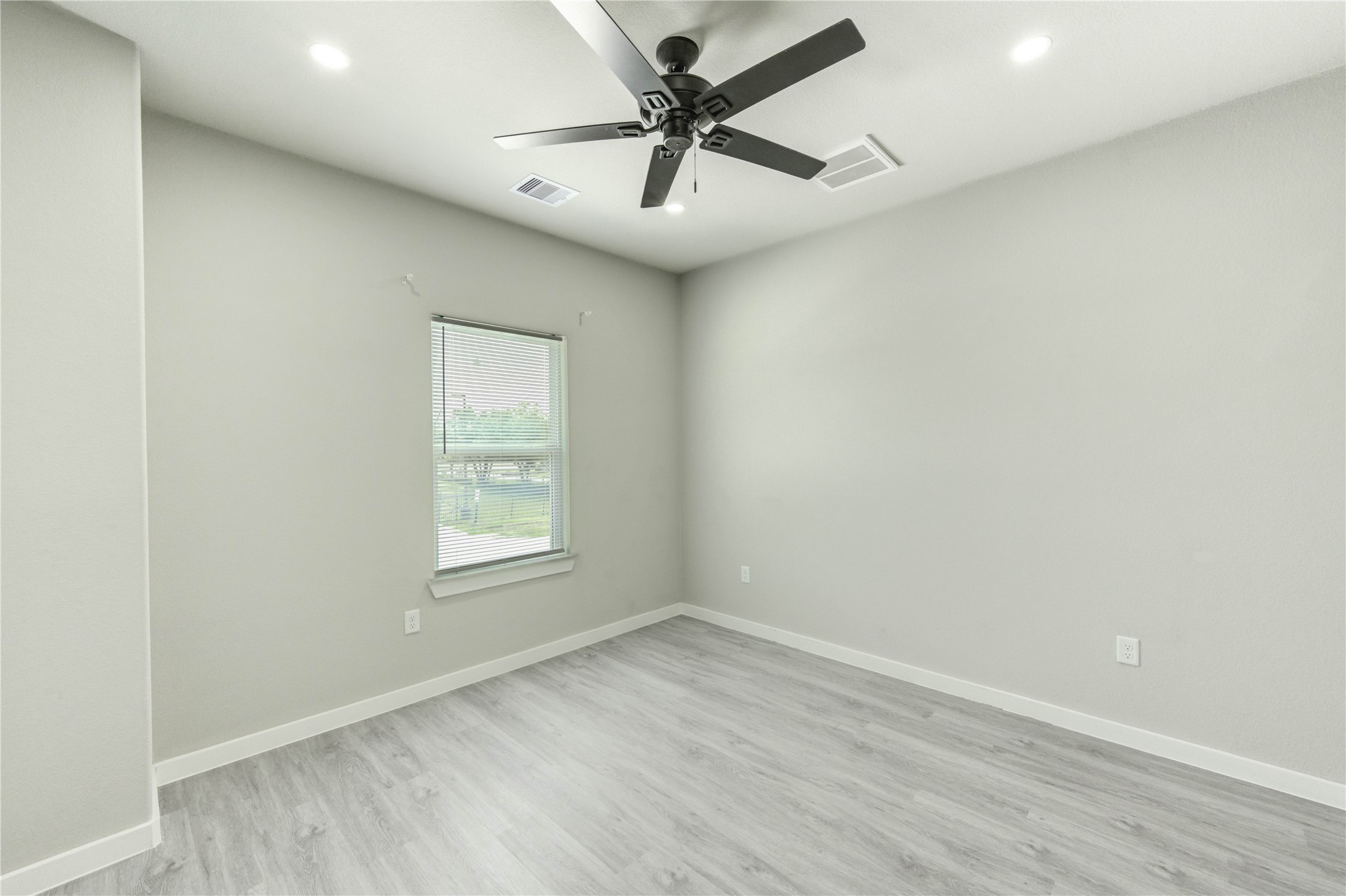 8157 Tate Street, Unit A Houston, TX 77028 - Photo 27 of 29 an empty room with a window and a ceiling fan