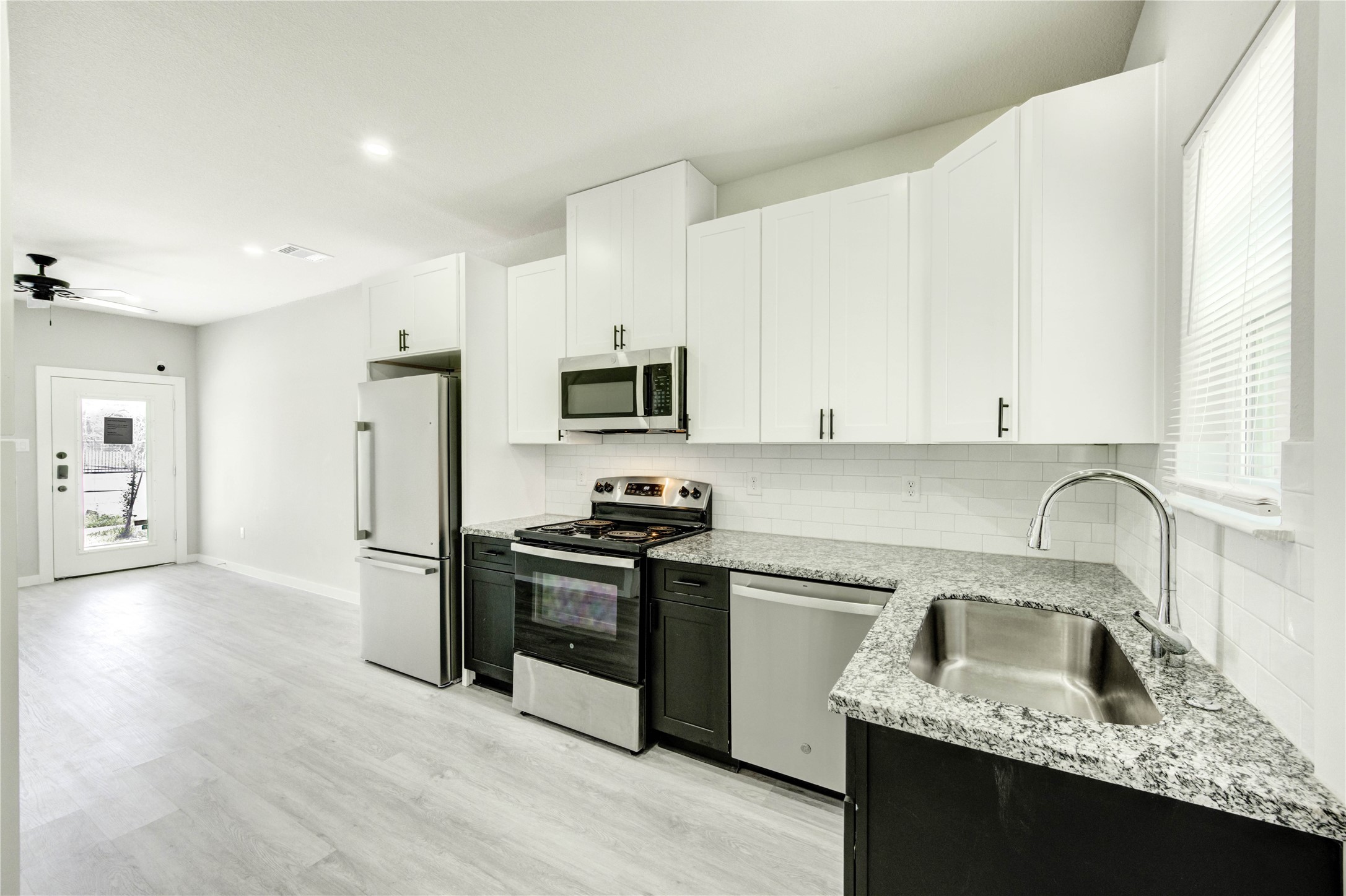 8157 Tate Street, Unit A Houston, TX 77028 - Photo 4 of 29 a kitchen with granite countertop a sink stove and refrigerator