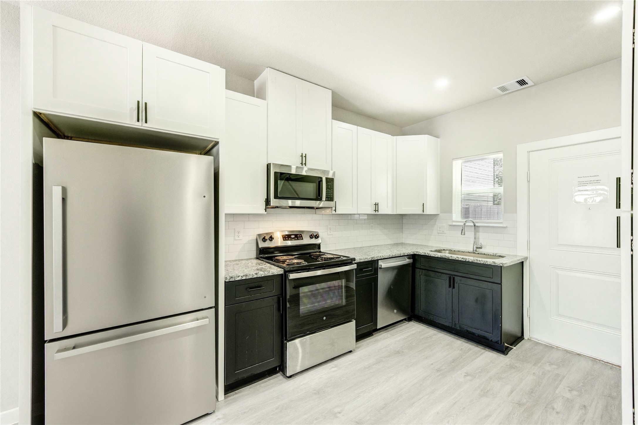 8157 Tate Street, Unit A Houston, TX 77028 - Photo 6 of 29 a kitchen with stainless steel appliances granite countertop a refrigerator a stove a sink and a microwave