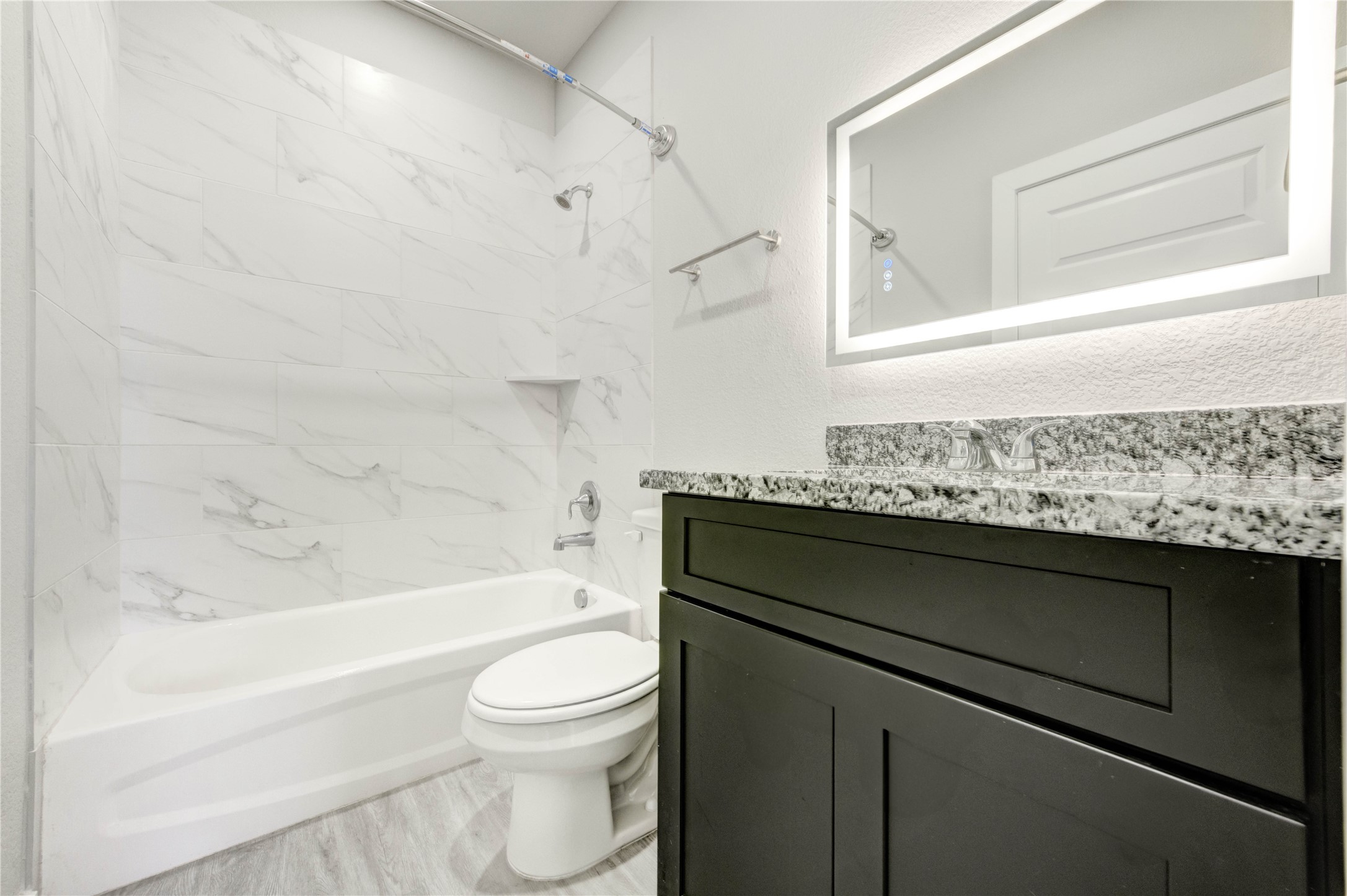 8157 Tate Street, Unit A Houston, TX 77028 - Photo 10 of 29 a bathroom with a granite countertop toilet sink and mirror