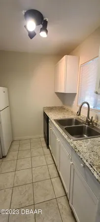 a kitchen with a sink a stove and cabinets