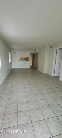 a view of an empty room and entryway