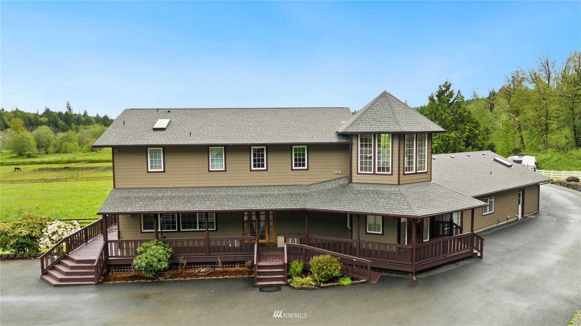 a front view of a house with a garden and plants