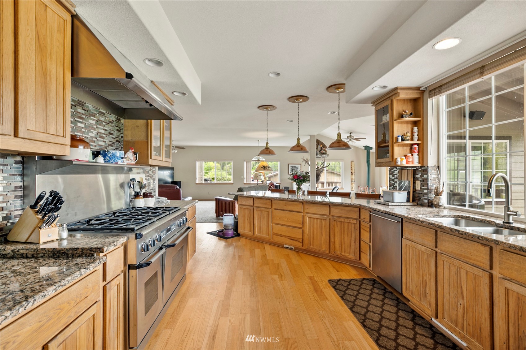 300 West Elk Ridge Road Shelton, WA 98584 - Photo 12 of 40 a kitchen with stainless steel appliances kitchen island granite countertop a sink stove and cabinets