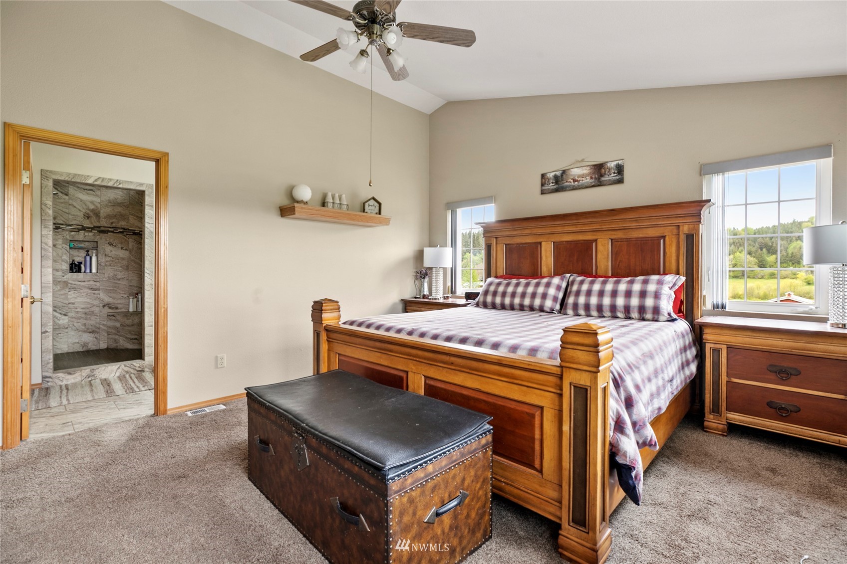 300 West Elk Ridge Road Shelton, WA 98584 - Photo 19 of 40 a bedroom with a bed and a chandelier
