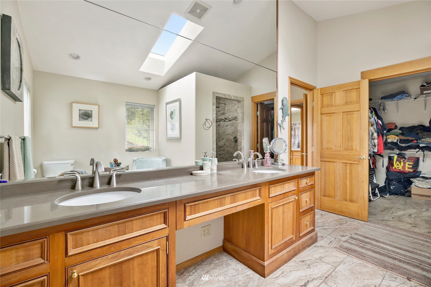 300 West Elk Ridge Road Shelton, WA 98584 - Photo 20 of 40 a spacious bathroom with a sink a mirror and a bathtub