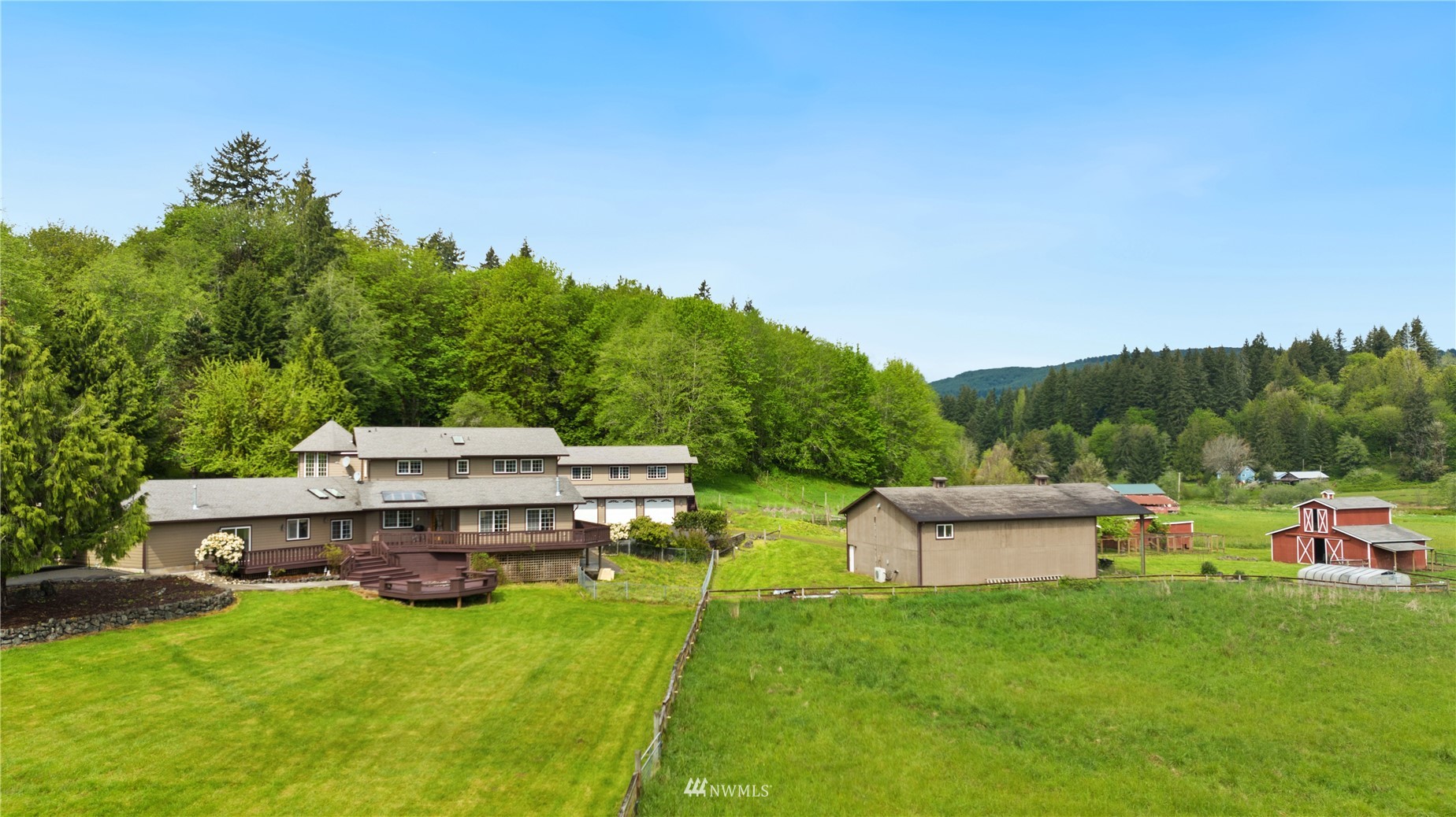 300 West Elk Ridge Road Shelton, WA 98584 - Photo 6 of 40 a view of a house with a big yard potted plants and a palm tree