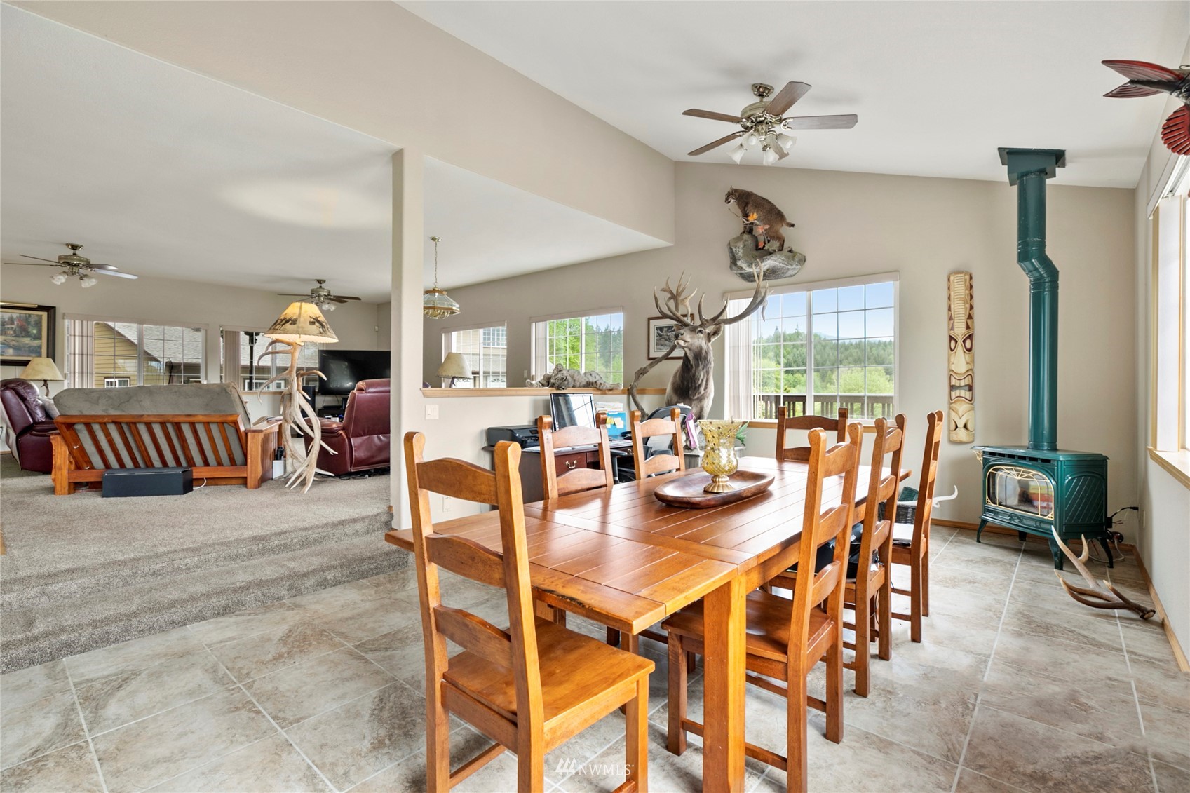 300 West Elk Ridge Road Shelton, WA 98584 - Photo 9 of 40 a dining room with furniture and a clock