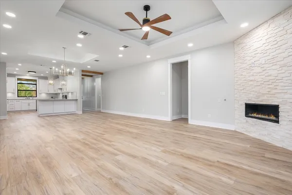 a view of an empty room with a kitchen