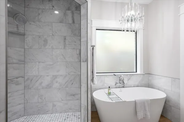 a bathroom with a bathtub and shower