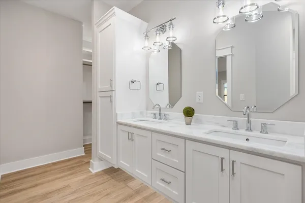 a bathroom with a double vanity sink and a mirror