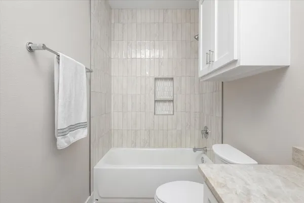 a bathroom with a toilet and a bathtub