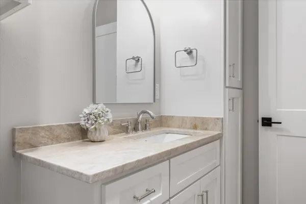 a bathroom with a sink and a mirror