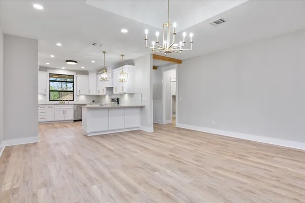 a view of a kitchen with a sink stainless steel appliances and cabinets