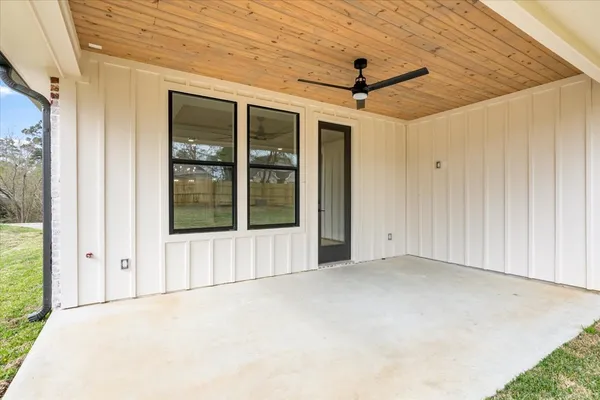 a view of a yard in front of a house with large trees