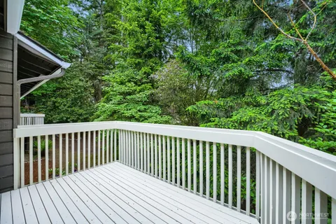 a balcony with wooden floor and fence