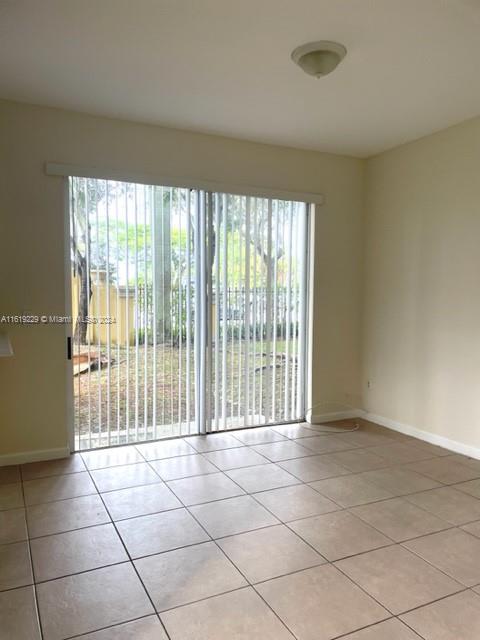 2133 Northeast 7th Street, Unit 2133 Homestead, FL 33033 - Photo 11 of 28 a view of an empty room with a window