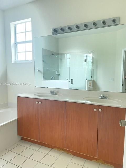 2133 Northeast 7th Street, Unit 2133 Homestead, FL 33033 - Photo 18 of 28 a bathroom with a granite countertop sink and mirror