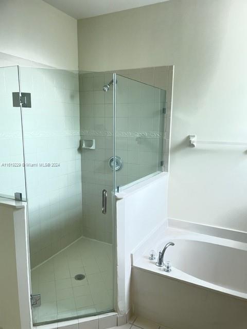 2133 Northeast 7th Street, Unit 2133 Homestead, FL 33033 - Photo 19 of 28 a bathroom with a bathtub and shower