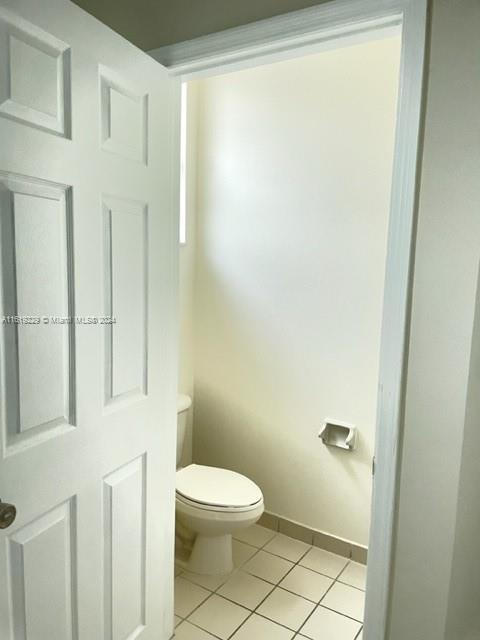 2133 Northeast 7th Street, Unit 2133 Homestead, FL 33033 - Photo 20 of 28 a white toilet sitting next to a bathroom sink
