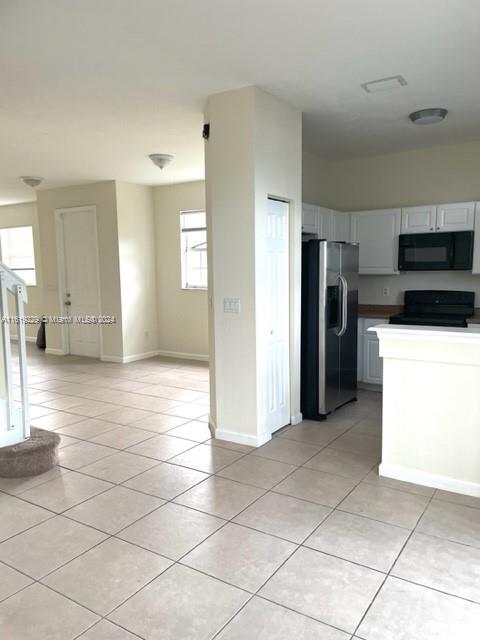 2133 Northeast 7th Street, Unit 2133 Homestead, FL 33033 - Photo 24 of 28 a view of a kitchen with a sink and an empty room