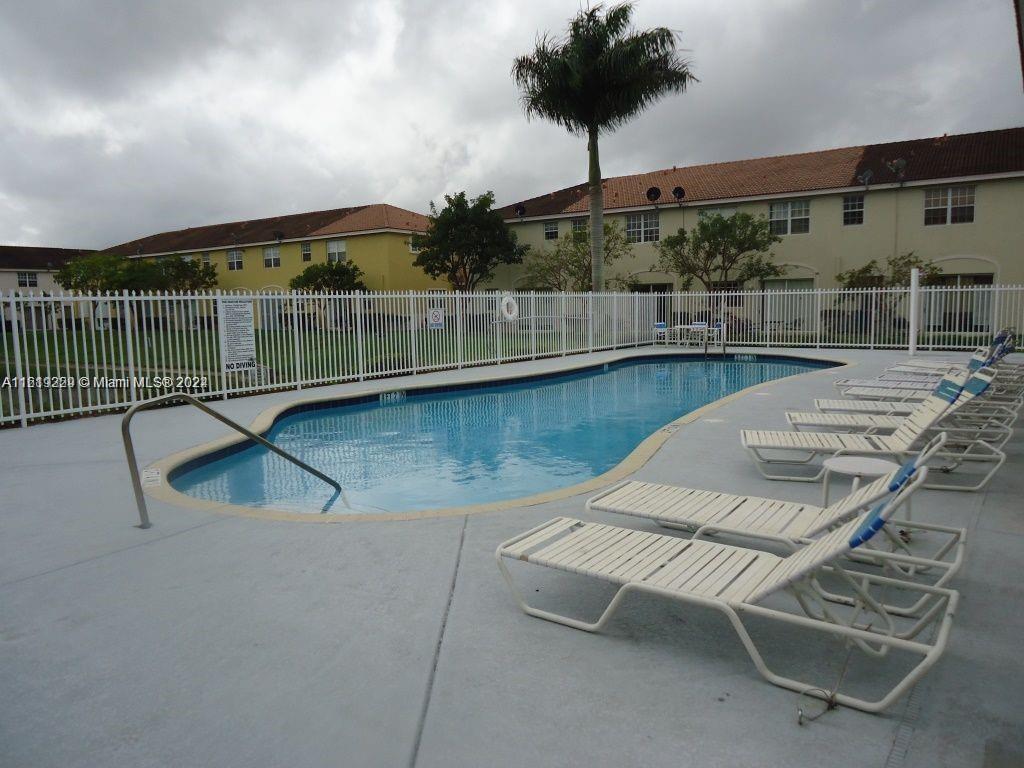 2133 Northeast 7th Street, Unit 2133 Homestead, FL 33033 - Photo 26 of 28 a view of a swimming pool with a chair