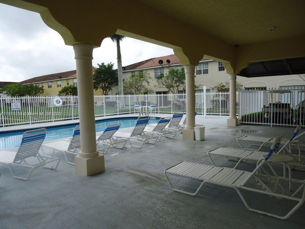 2133 Northeast 7th Street, Unit 2133 Homestead, FL 33033 - Photo 27 of 28 a view of a porch with chairs