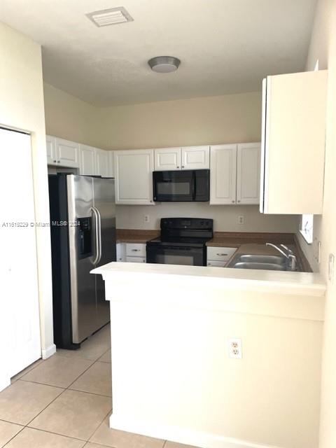 2133 Northeast 7th Street, Unit 2133 Homestead, FL 33033 - Photo 6 of 28 a kitchen with stainless steel appliances granite countertop a refrigerator a stove top oven a sink and dishwasher