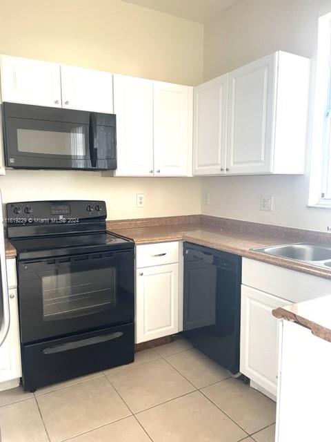 2133 Northeast 7th Street, Unit 2133 Homestead, FL 33033 - Photo 7 of 28 a kitchen with granite countertop white cabinets and stainless steel appliances