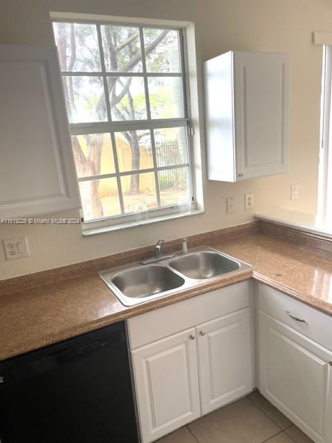 2133 Northeast 7th Street, Unit 2133 Homestead, FL 33033 - Photo 8 of 28 a kitchen with granite countertop a sink and a window