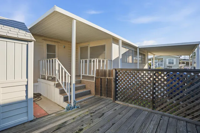 a view of a house with wooden deck front door