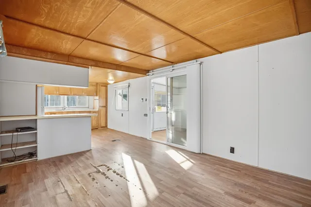 a view of a room with wooden floor