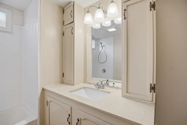 a bathroom with a sink vanity and a mirror