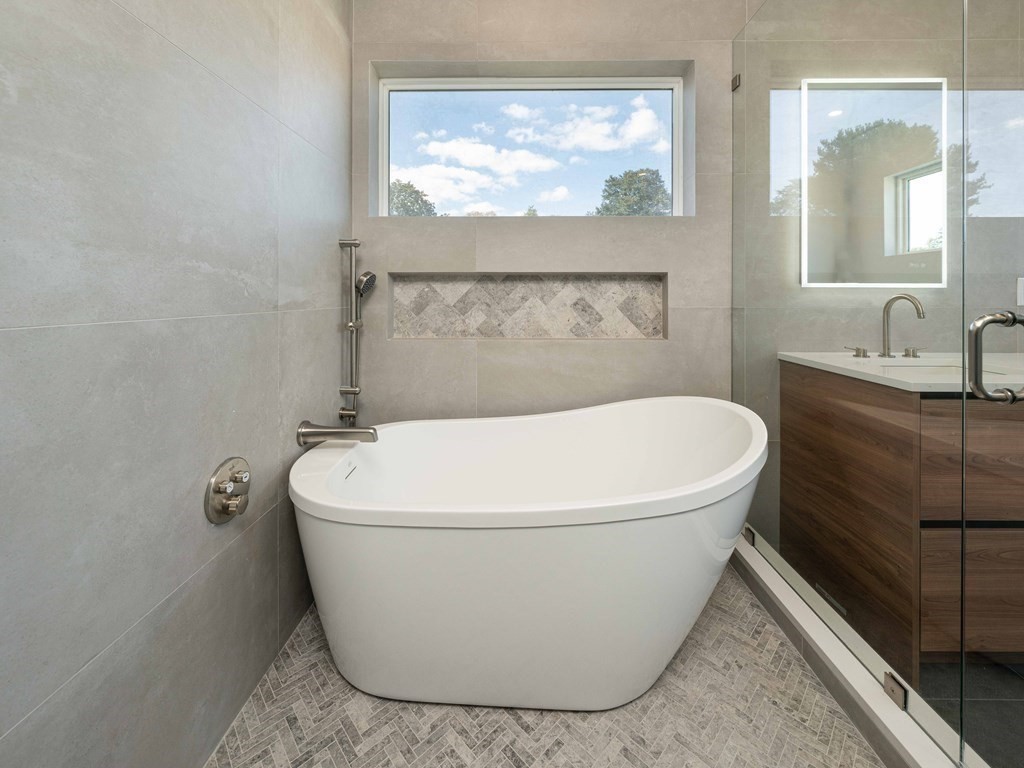 21 Cavanaugh Path Newton, MA 02459 - Photo 13 of 30 a white bath tub sitting in a bathroom