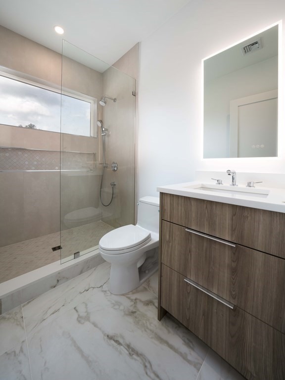 21 Cavanaugh Path Newton, MA 02459 - Photo 16 of 30 a bathroom with a toilet sink and shower