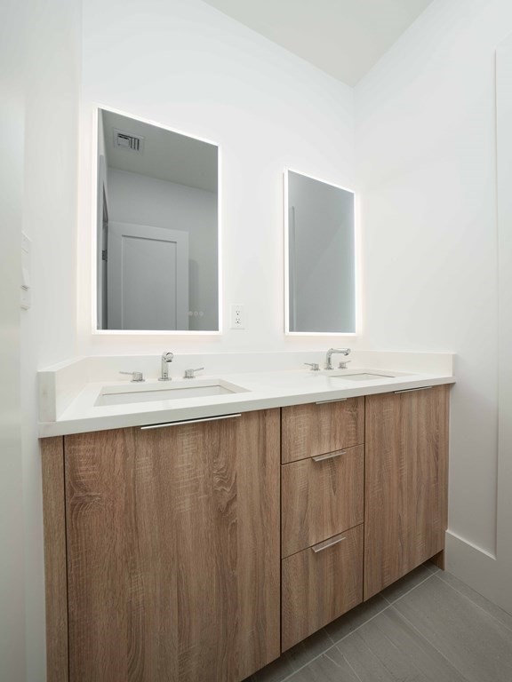 21 Cavanaugh Path Newton, MA 02459 - Photo 18 of 30 a bathroom with double vanity and a mirror