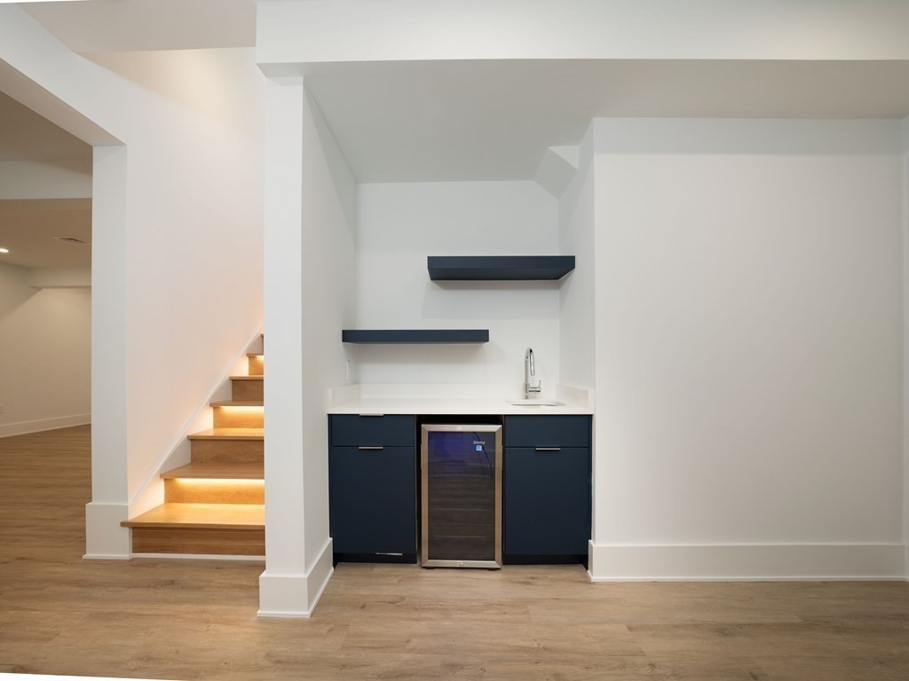 21 Cavanaugh Path Newton, MA 02459 - Photo 24 of 30 a view of a hallway with wooden floor and staircase