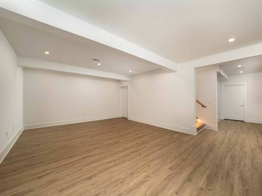 21 Cavanaugh Path Newton, MA 02459 - Photo 25 of 30 a view of empty room with wooden floor and fence